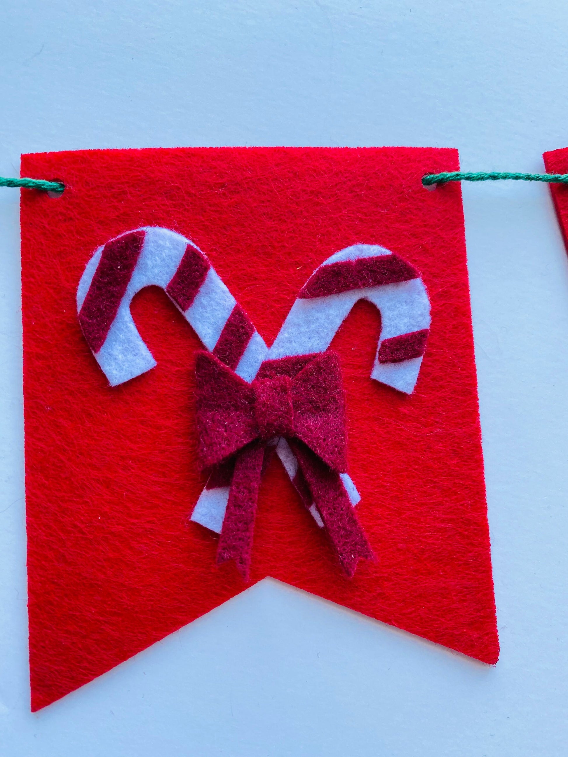Christmas Flag Bunting with Pennants featuring Mistletoe, Candy Canes, Sleigh, Candle with Lantern, and Pinecone