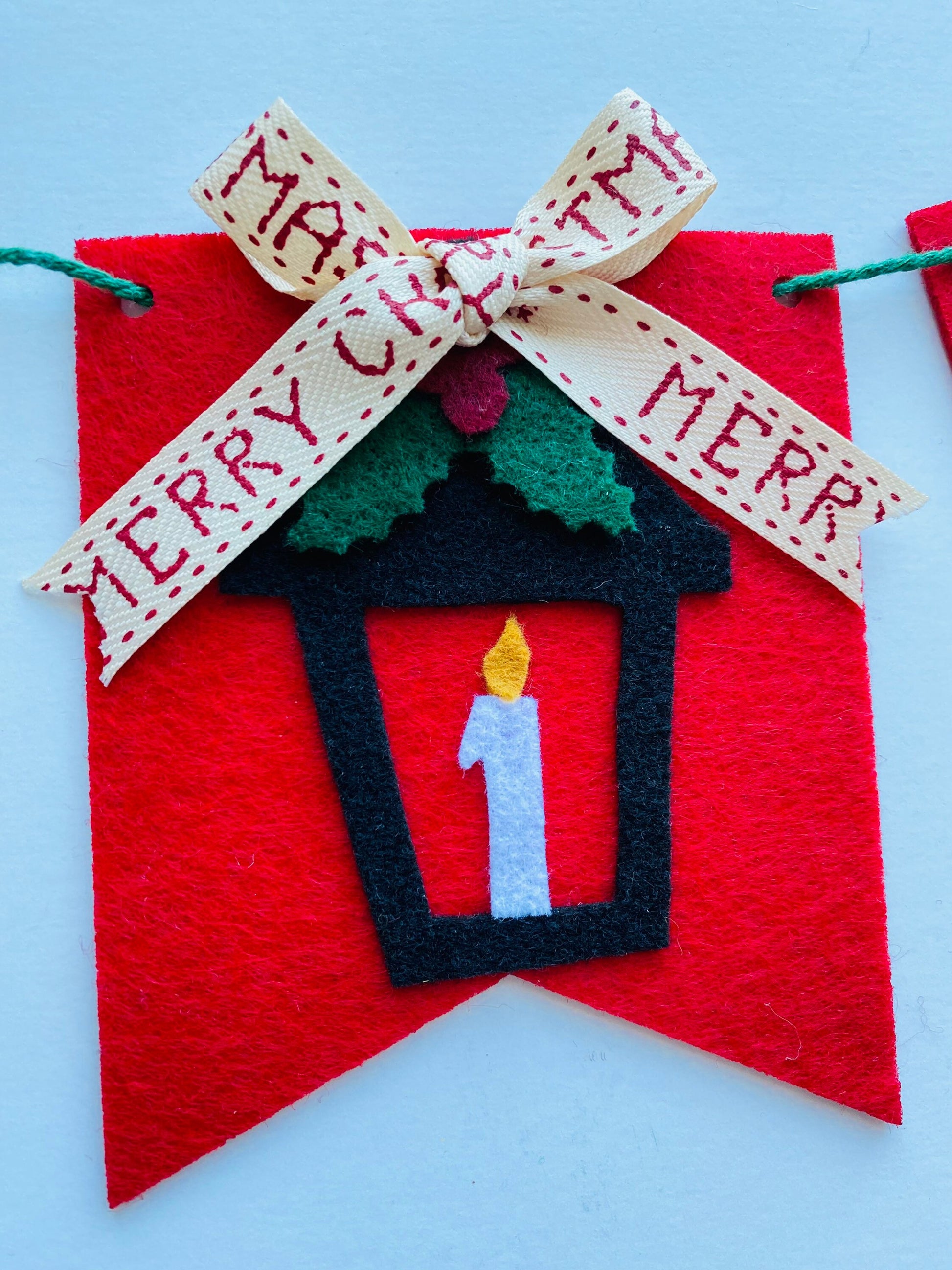 Christmas Flag Bunting with Pennants featuring Mistletoe, Candy Canes, Sleigh, Candle with Lantern, and Pinecone