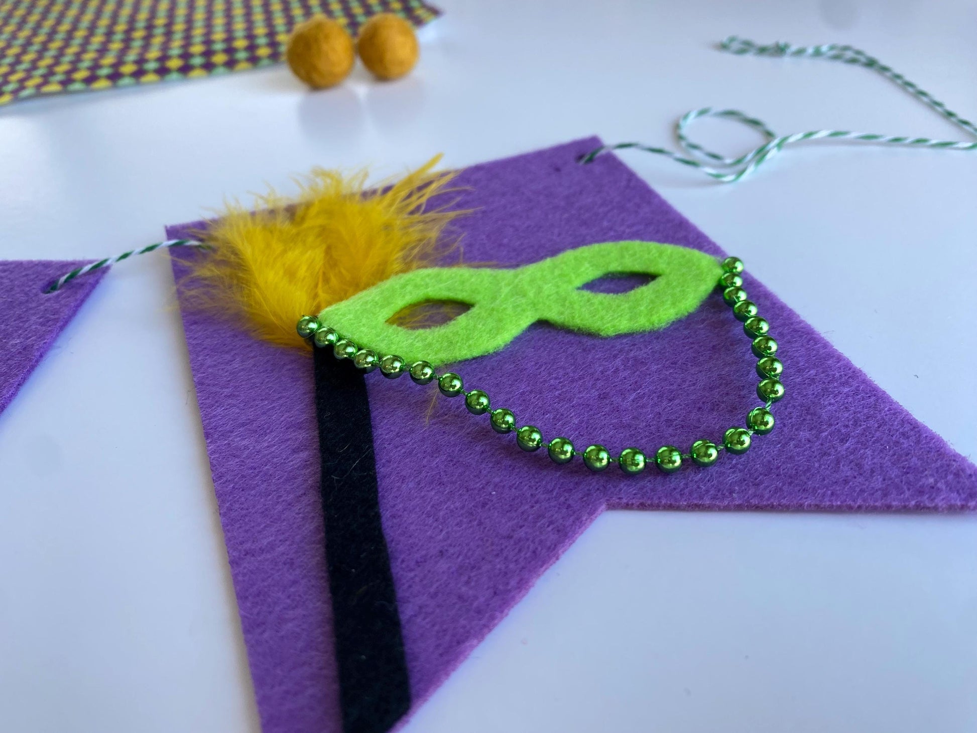 Mardi Gras Flag Bunting with Pennants featuring Bourbon St, King Cake, Masks, Fleur de Lis, Drinks, Beads, and Saxophone