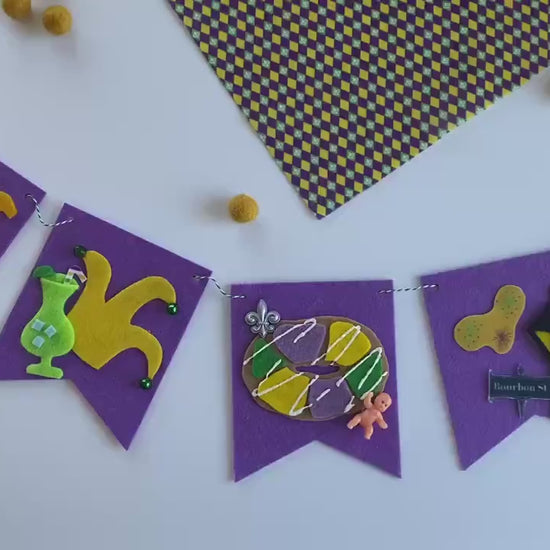 Mardi Gras Flag Bunting with Pennants featuring Bourbon St, King Cake, Masks, Fleur de Lis, Drinks, Beads, and Saxophone